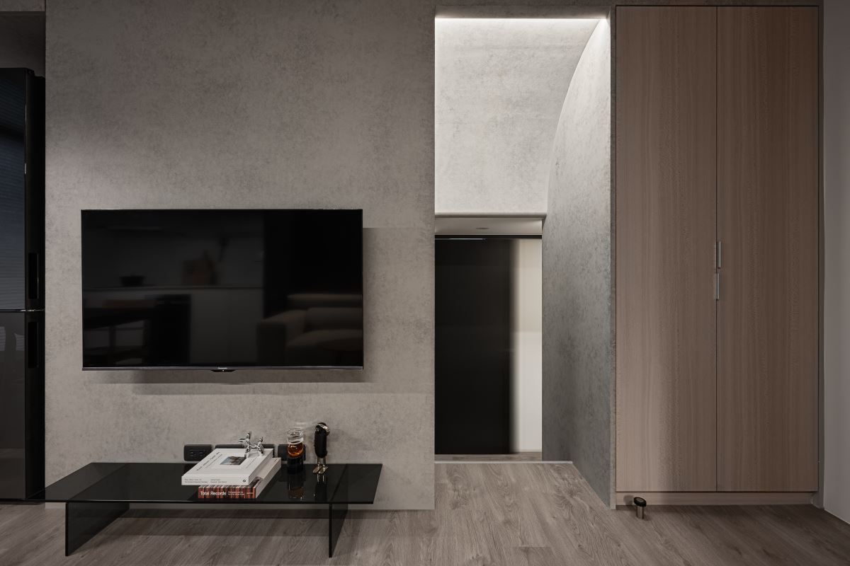 為了營造低調奢華感,電視牆選用清水模層層堆疊,呈現大面積淡淡的紋理,增加整體手作的獨特性。