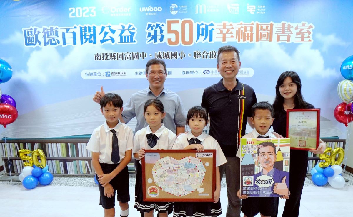 為了感謝歐德集團打造幸福圖書室，成城國小的孩子寫了愛心小卡致贈給董事長陳國都(後排中)。