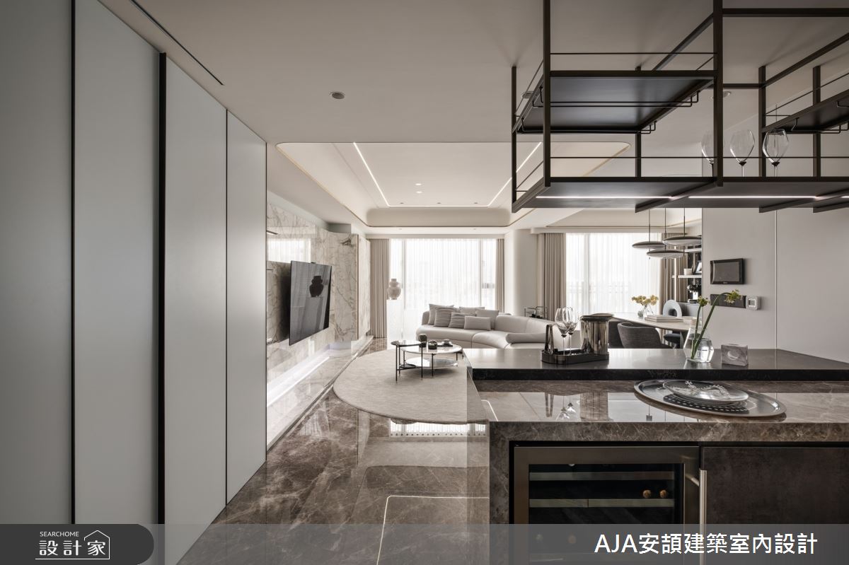 門口中島享有觀覽客廳的視野,以餐食功能作為公領域的互動樞紐,讓主人能隨時留意賓客動態。