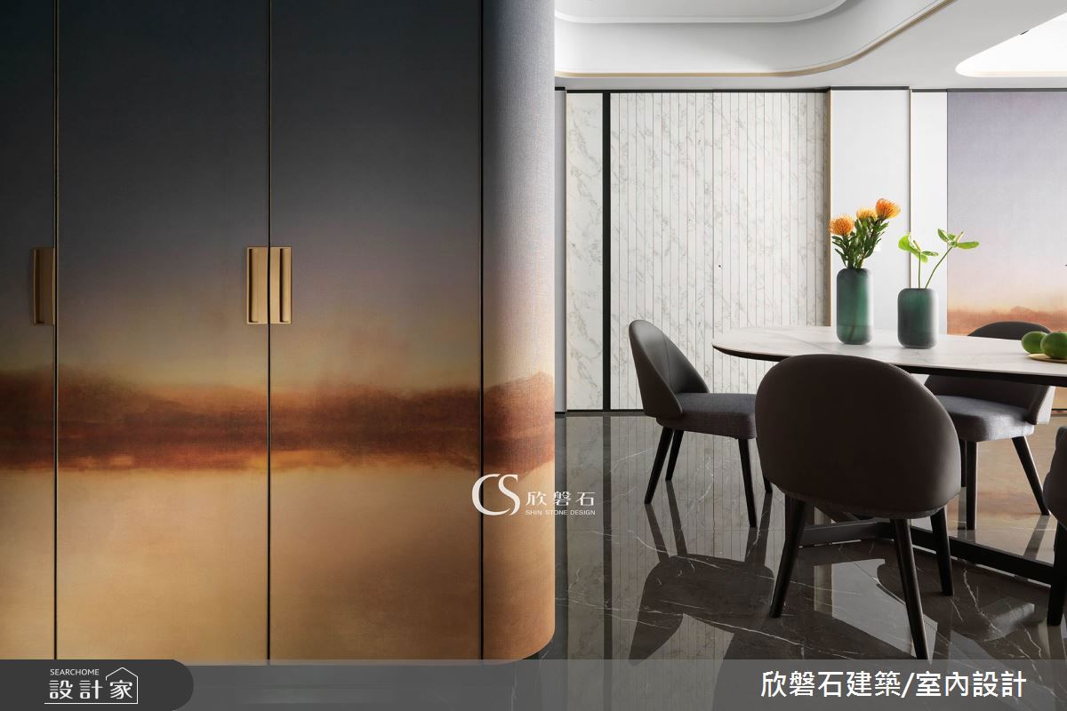 玄關漸層瑰麗色調的壁布，覆蓋鞋櫃延伸到餐廳沙發側，相同材質創造視覺延伸感