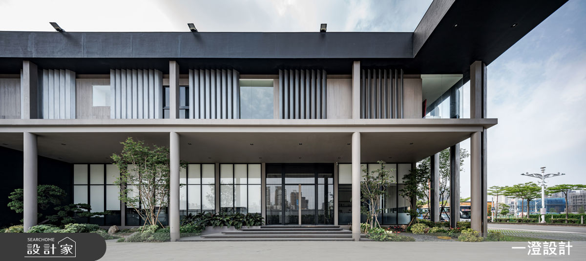 建築外觀以深色立面與格柵線條界定氣度，沉穩如序章。
