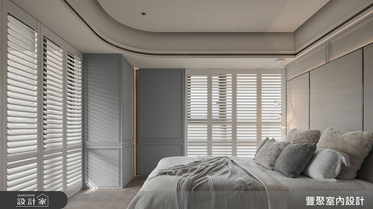 主臥房融入女屋主偏好的美式線板語言，搭配溫潤色調與金屬飾條，展現優雅深度。結構柱體以莫蘭迪藍跳色，延續整體現代時尚感。